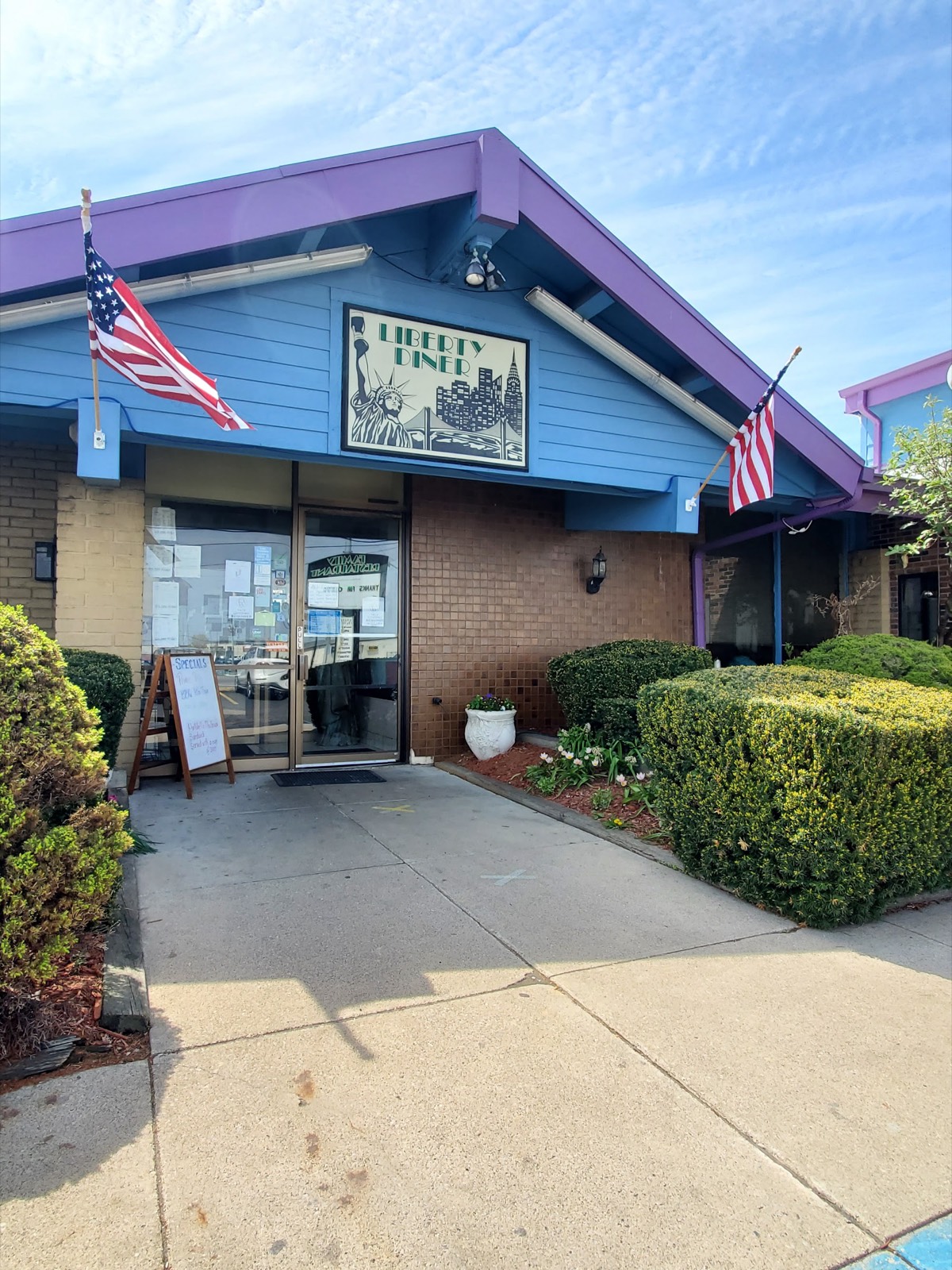 Liberty Diner storefront on Goshen Road, Fort Wayne, with American flags by the entrance