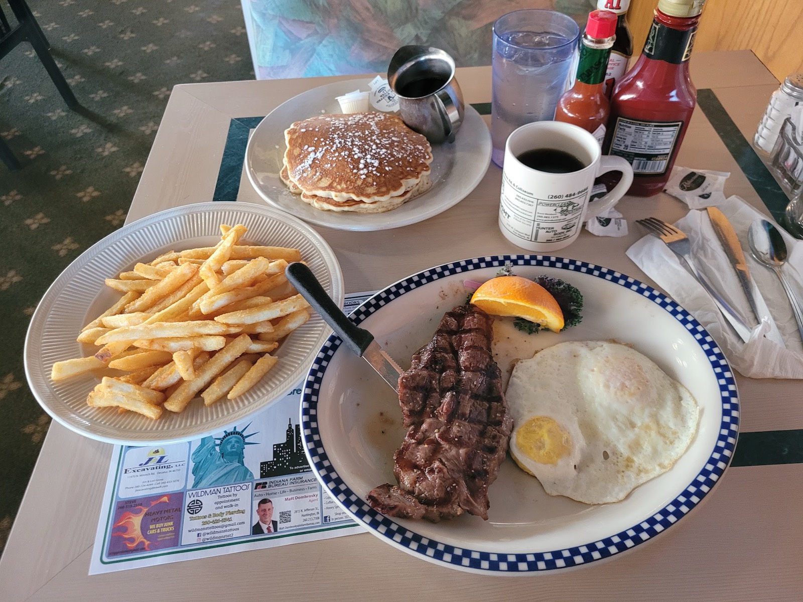 Steak and eggs breakfast combo with fries, pancakes and coffee